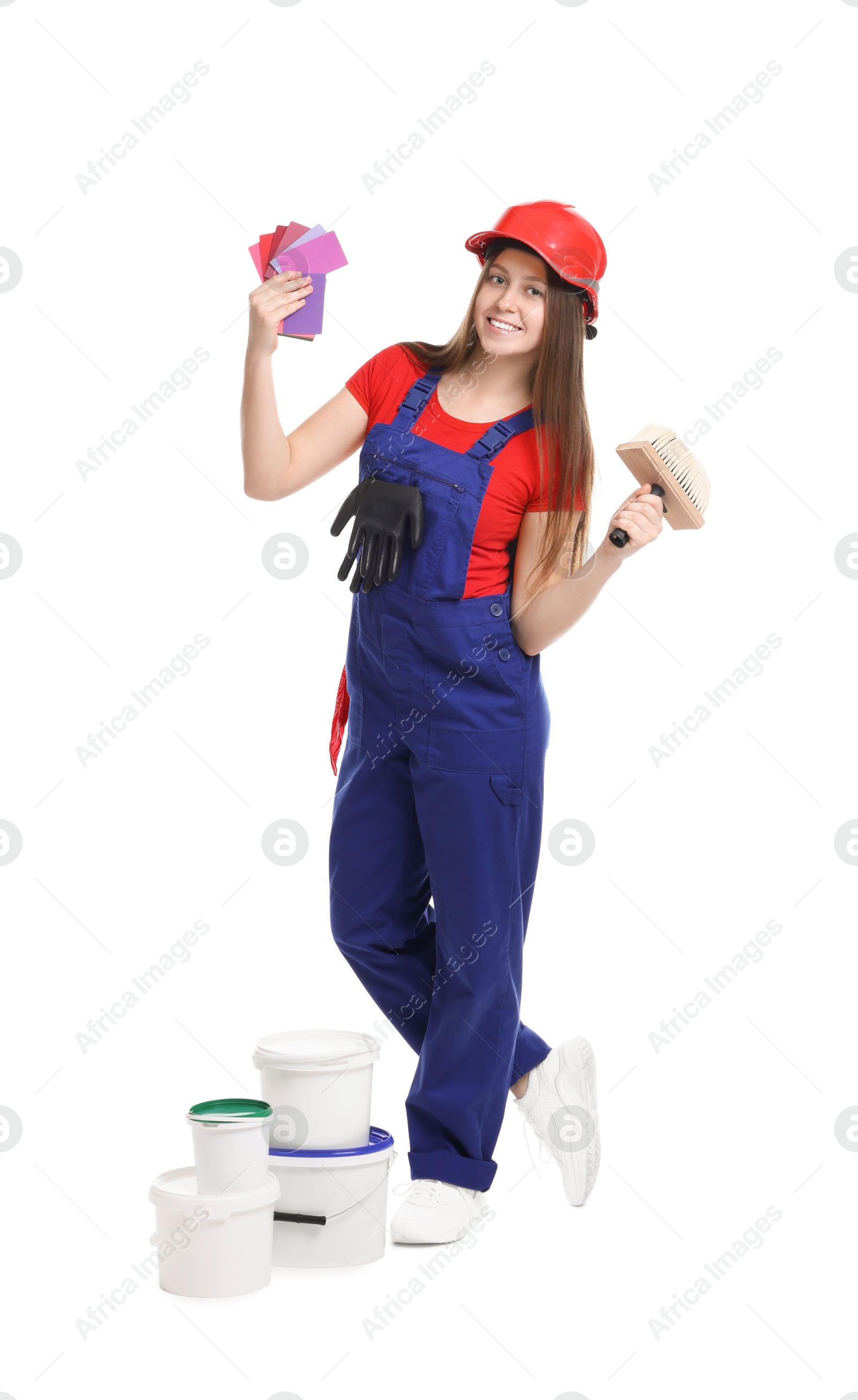 Photo of Professional painter with brush, color samples and buckets of paint on white background