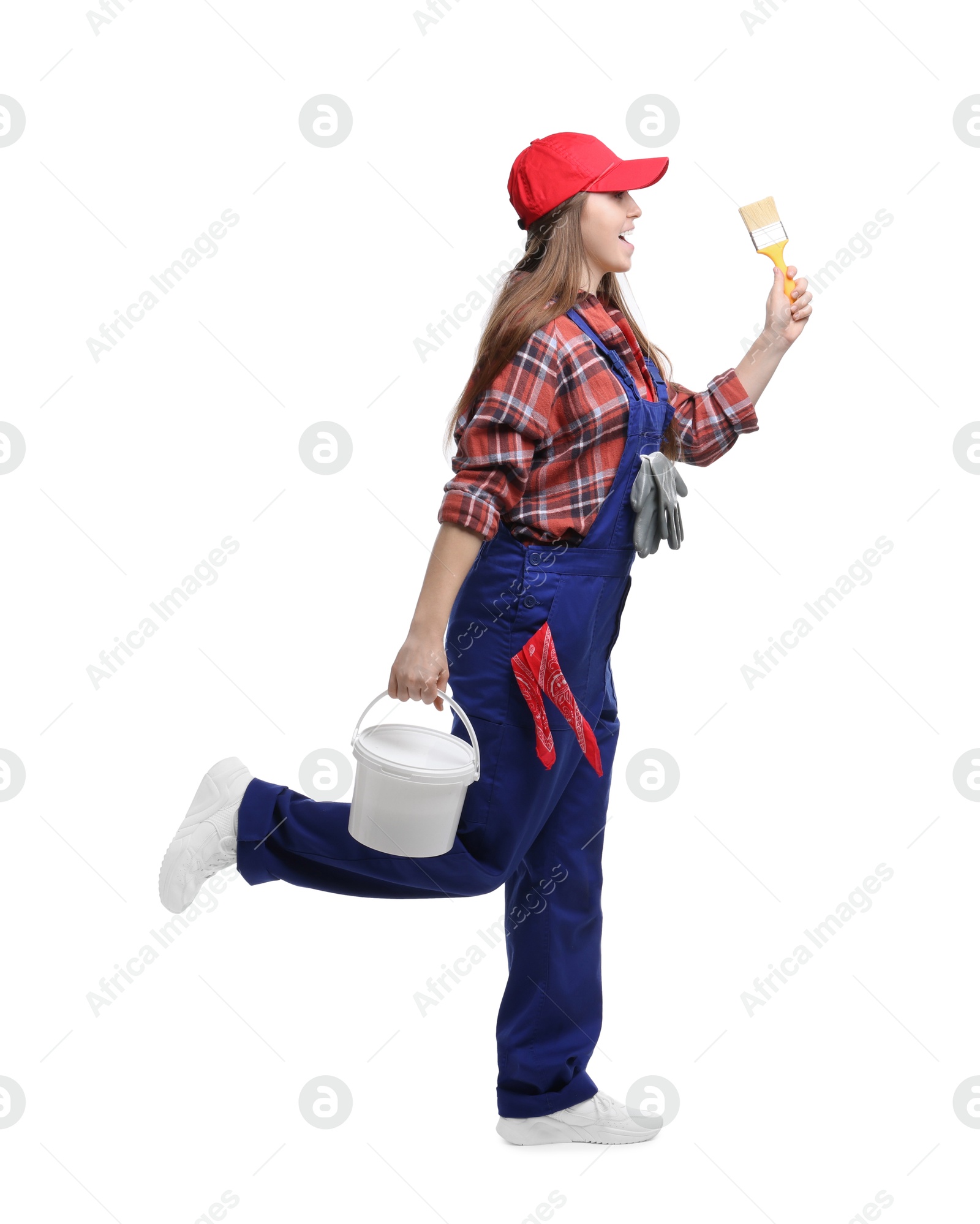 Photo of Professional painter with brush and bucket of paint on white background