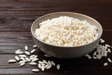 Photo of Puffed rice in bowl on wooden table, closeup