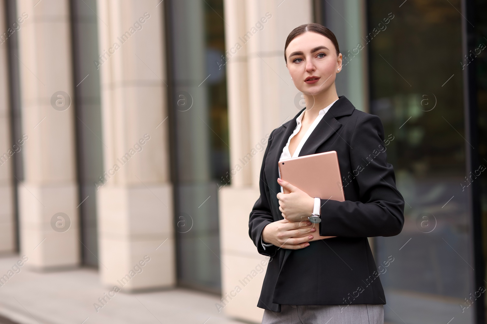 Photo of Woman in stylish formal suit with tablet outdoors. Space for text