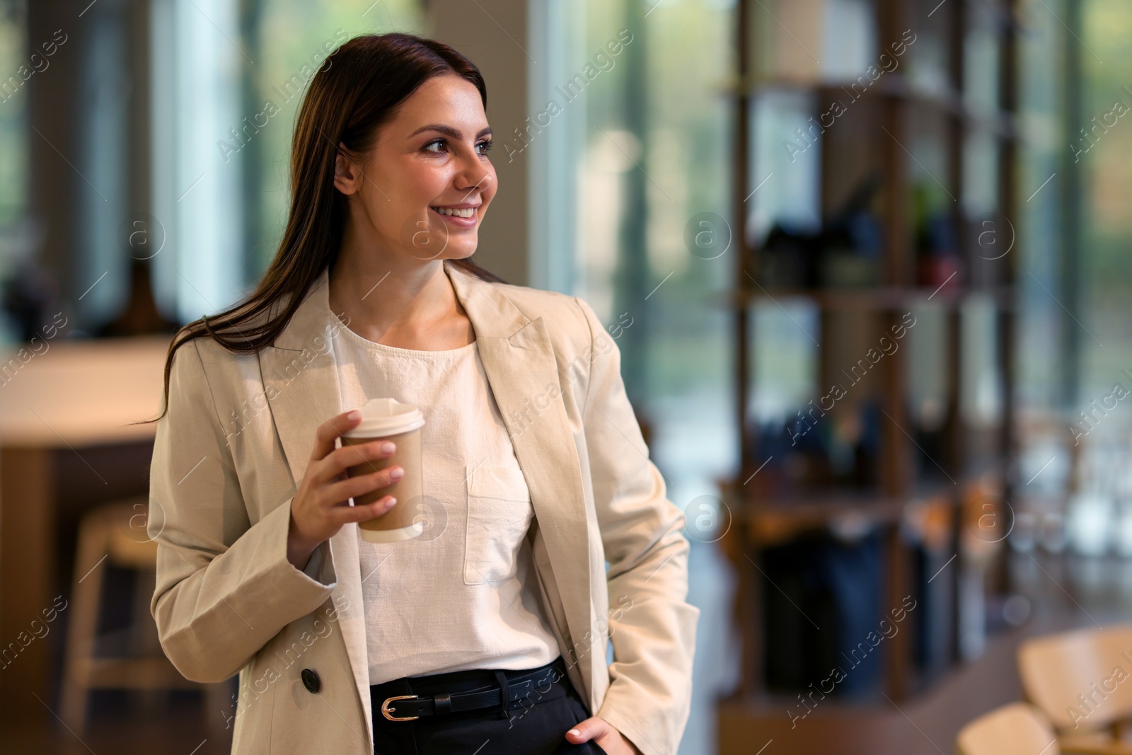 Photo of Woman in stylish formal suit with cup of coffee indoors. Space for text