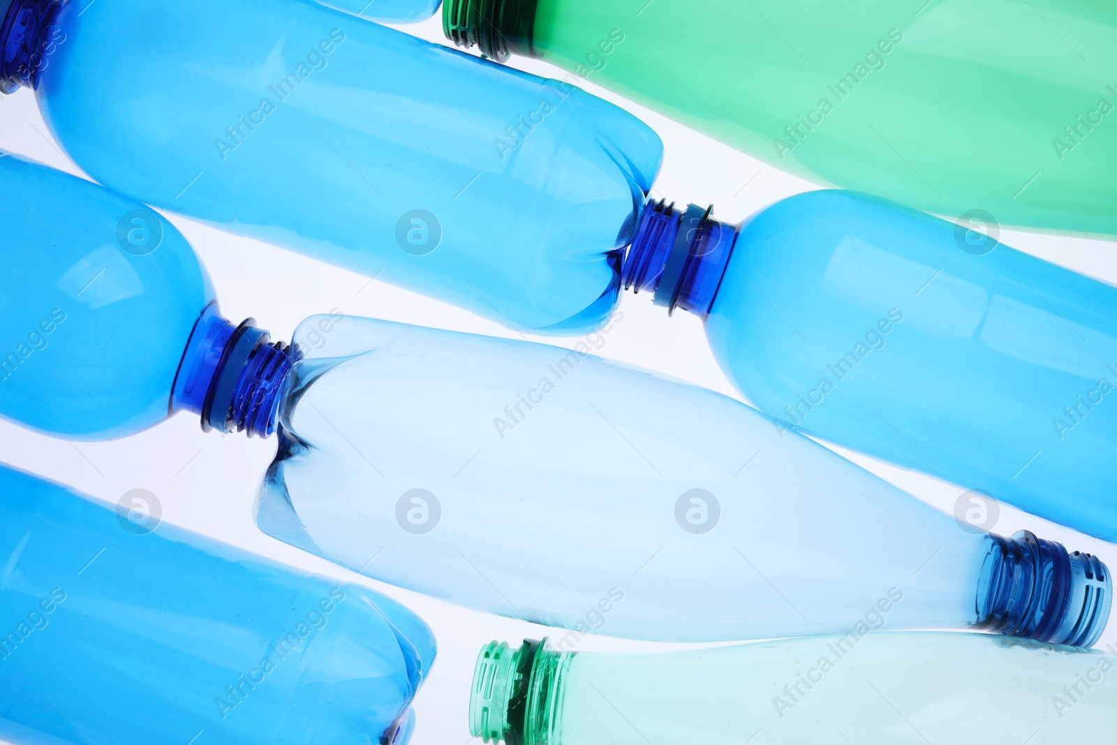 Photo of Empty plastic bottles on white background, top view