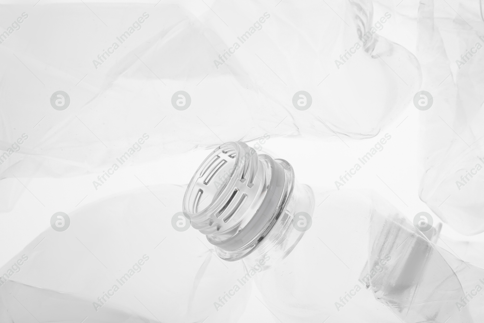 Photo of Crumpled plastic bottles on white background, closeup