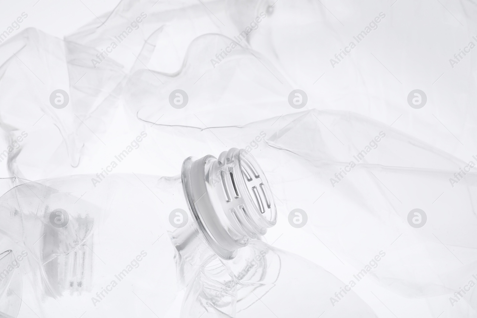 Photo of Crumpled plastic bottles on white background, closeup