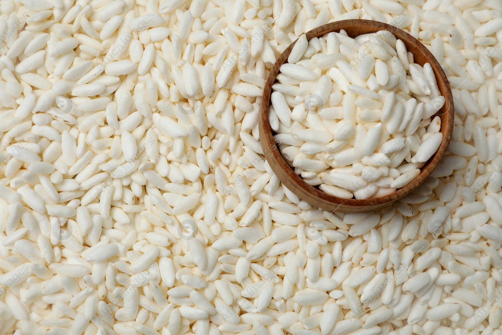 Photo of Bowl with puffed rice as background, closeup