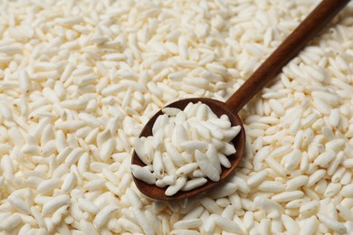 Photo of Spoon with puffed rice as background, closeup