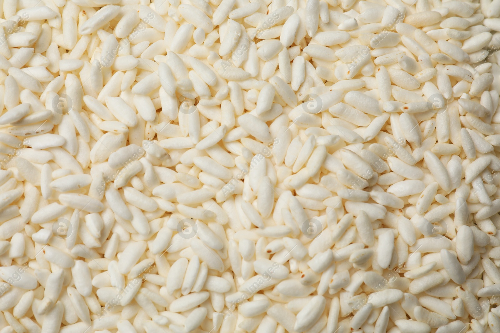 Photo of Wholegrain puffed rice as background, closeup view