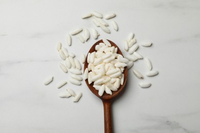 Photo of Spoon with puffed rice on white table, top view