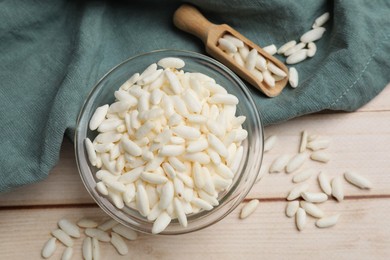 Photo of Puffed rice in bowl and scoop on white wooden table, flat lay