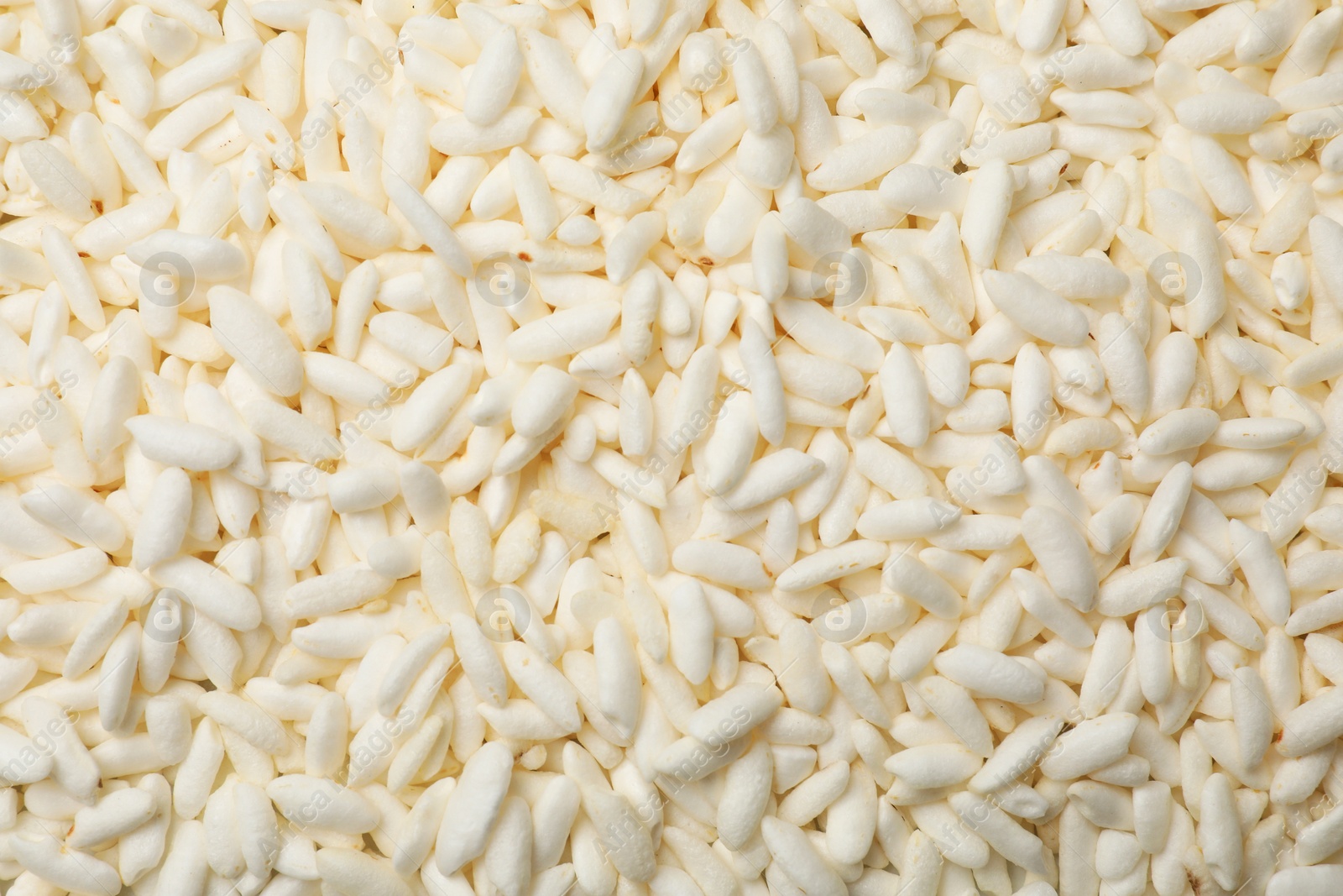 Photo of Wholegrain puffed rice as background, closeup view