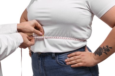 Photo of Weight loss. Nutritionist measuring patient's waist with tape on white background, closeup