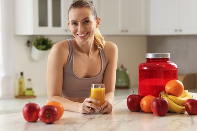 Photo of Weight loss. Happy woman with tasty shake at white marble table in kitchen