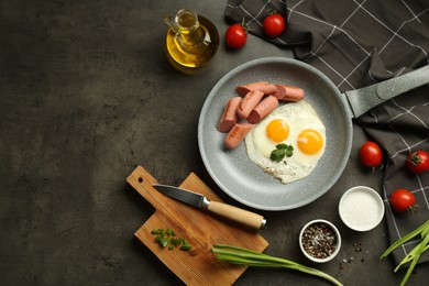 Photo of Tasty fried eggs and sausages served on grey table, flat lay. Space for text