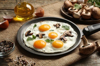 Photo of Tasty fried eggs with mushrooms and parsley served on wooden table