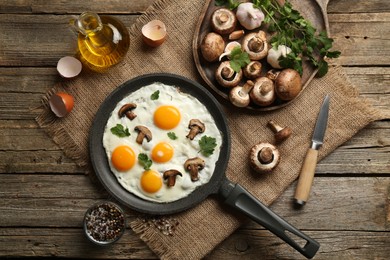 Photo of Tasty fried eggs with mushrooms and parsley served on wooden table, flat lay