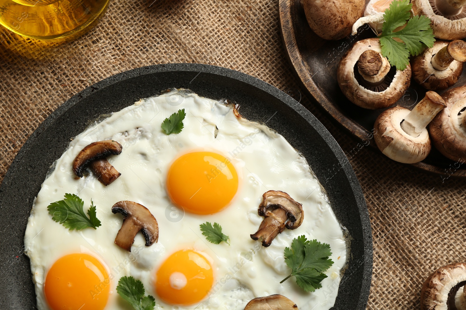 Photo of Tasty fried eggs with mushrooms and parsley served on table, flat lay