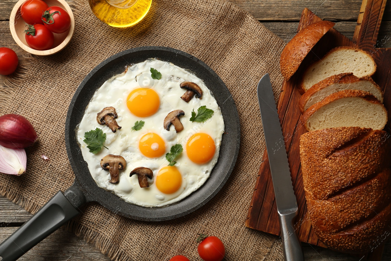 Photo of Tasty fried eggs with mushrooms and parsley served on wooden table, flat lay