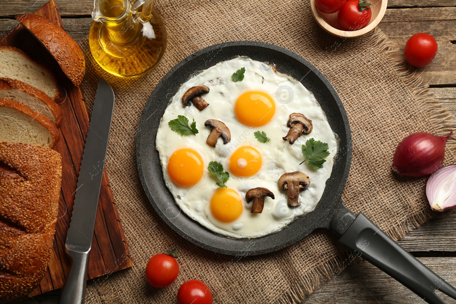 Photo of Tasty fried eggs with mushrooms and parsley served on wooden table, flat lay