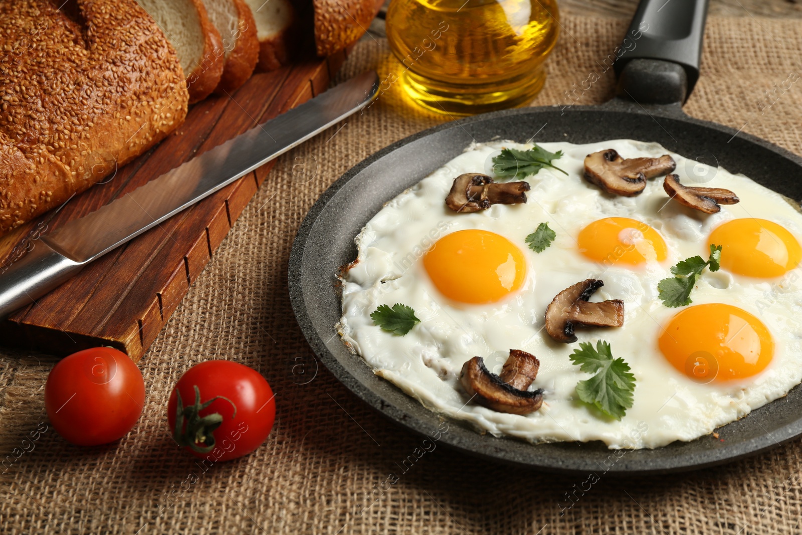 Photo of Tasty fried eggs with mushrooms and parsley served on table, closeup