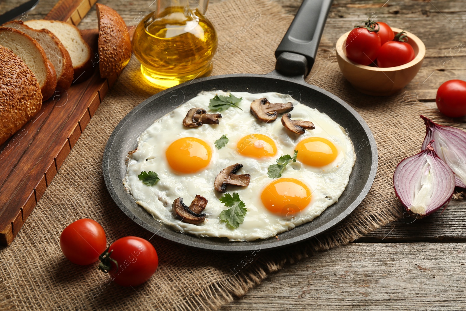 Photo of Tasty fried eggs with mushrooms and parsley served on wooden table