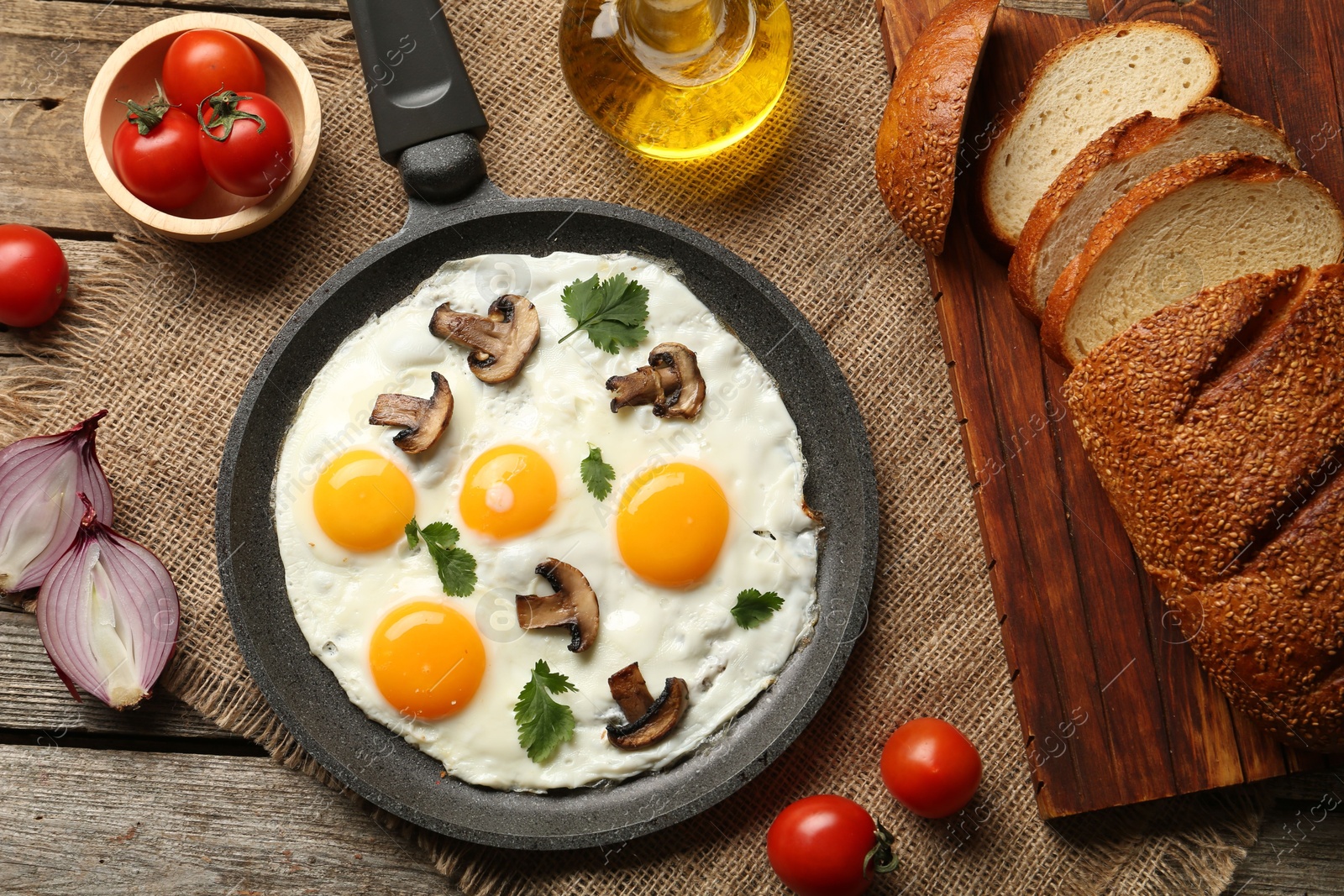 Photo of Tasty fried eggs with mushrooms and parsley served on wooden table, flat lay