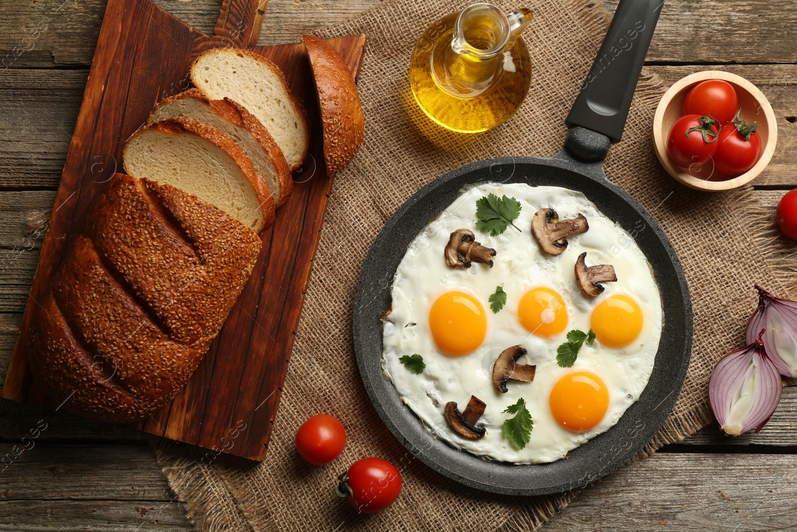 Photo of Tasty fried eggs with mushrooms and parsley served on wooden table, flat lay