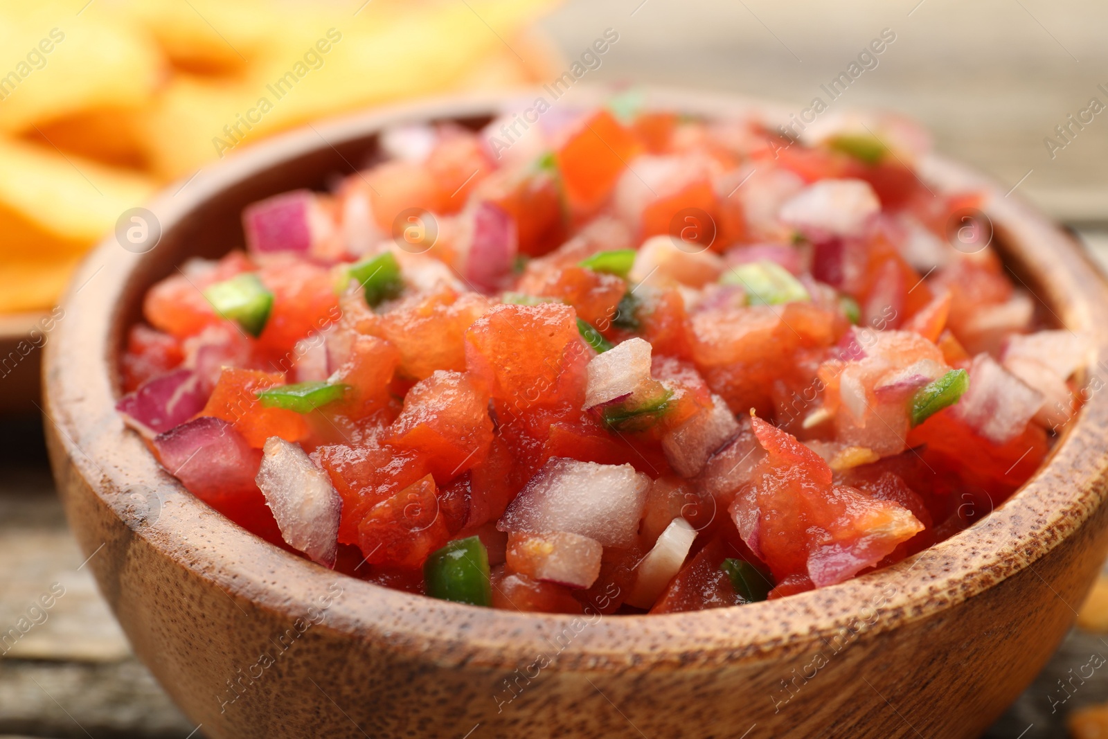 Photo of Delicious salsa in bowl on table, closeup