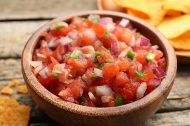 Photo of Delicious salsa in bowl on table, closeup