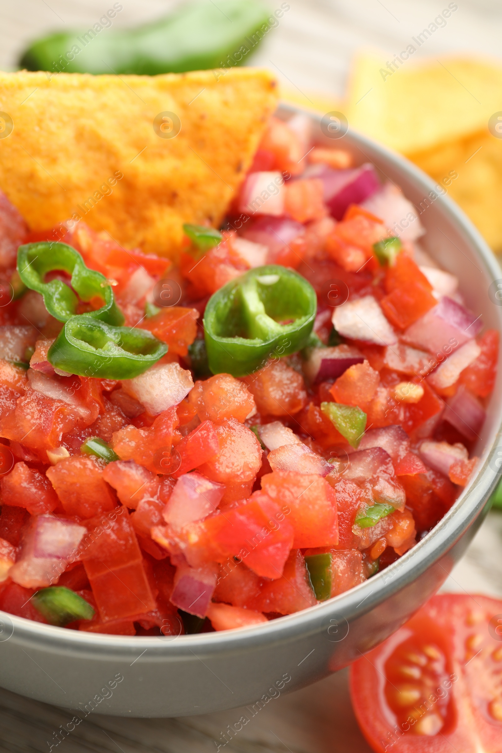 Photo of Delicious salsa and nacho in bowl on table, closeup