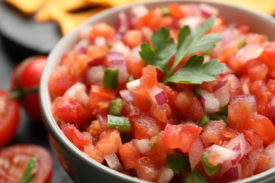 Delicious salsa in bowl on table, closeup