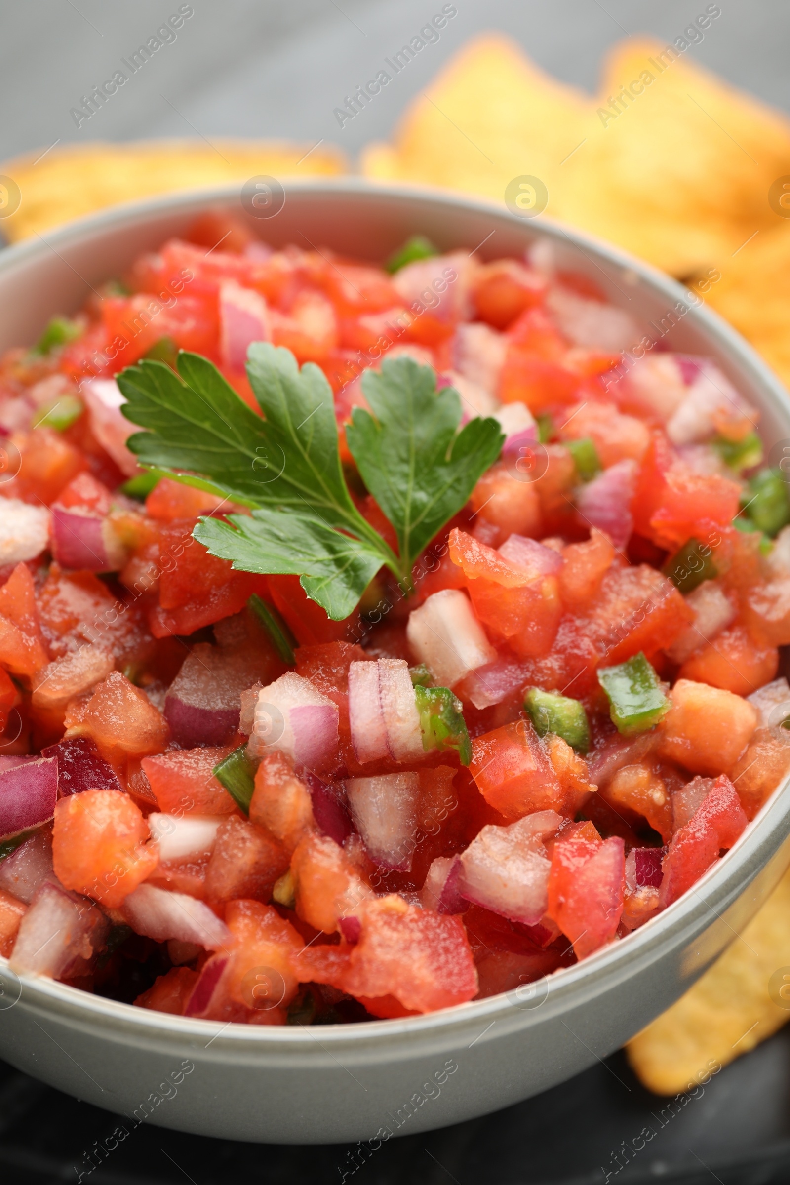 Photo of Delicious salsa in bowl on table, closeup