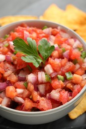 Photo of Delicious salsa in bowl on table, closeup