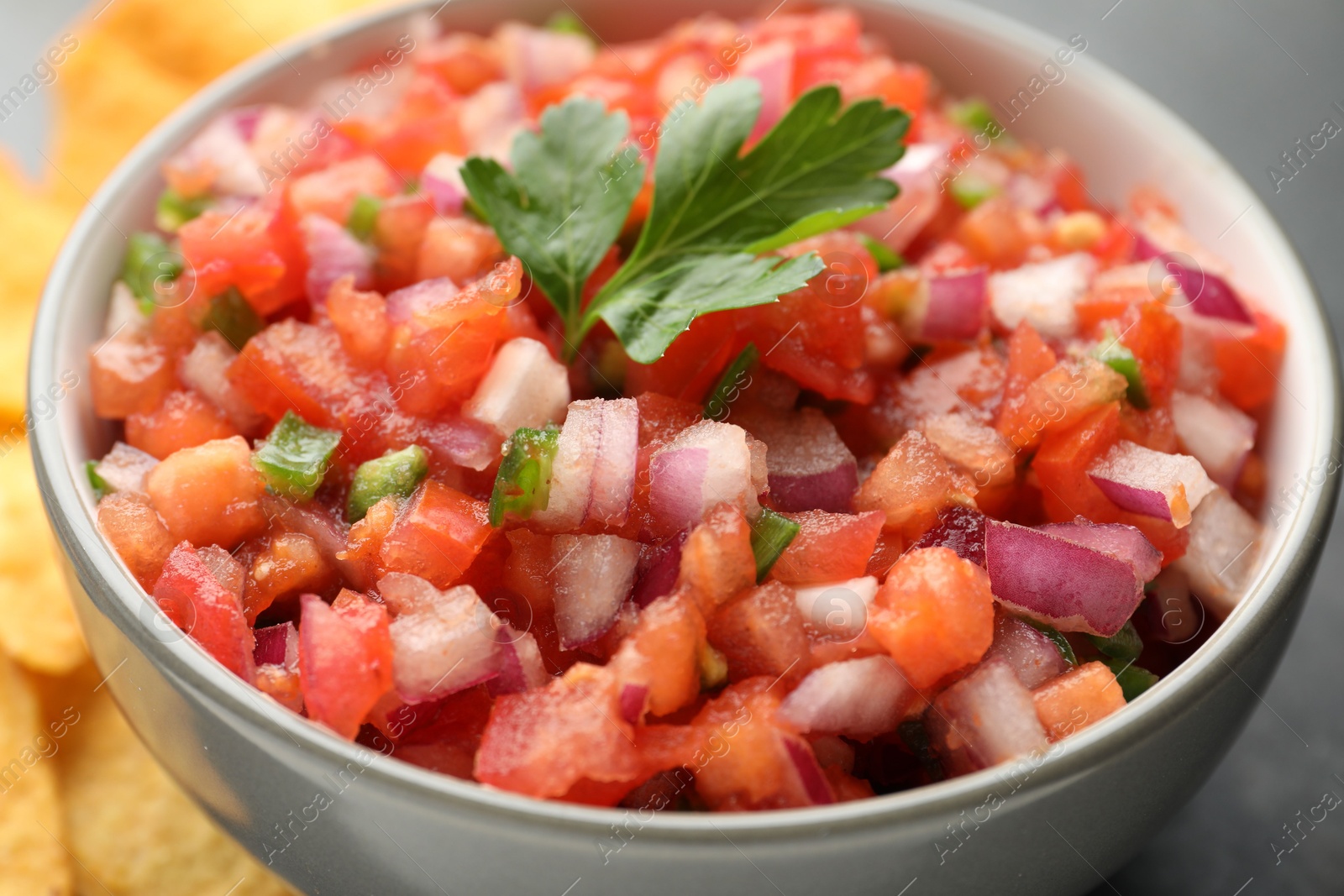 Photo of Delicious salsa in bowl on table, closeup