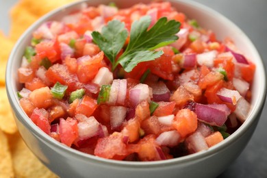 Delicious salsa in bowl on table, closeup