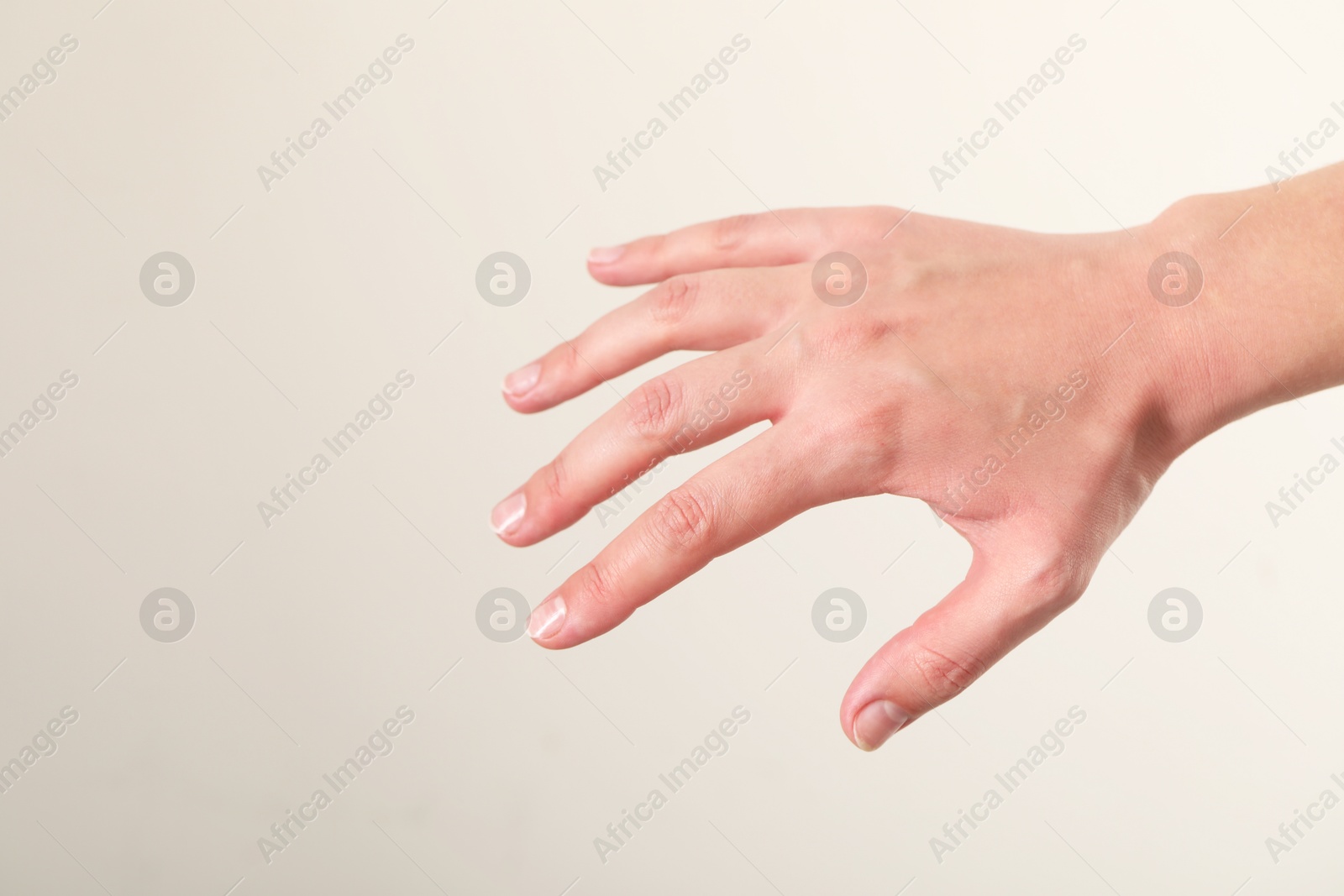 Photo of Woman with visible hand veins on white background, closeup