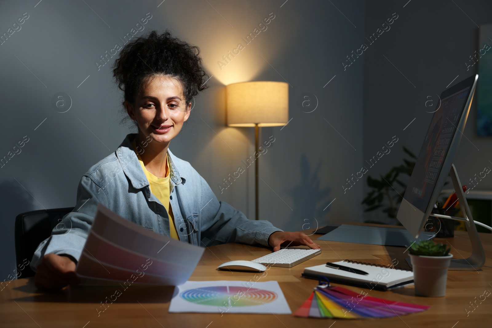 Photo of Designer with color palette working indoors at night