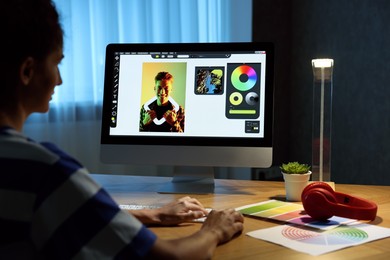 Photo of Designer working on computer indoors at night