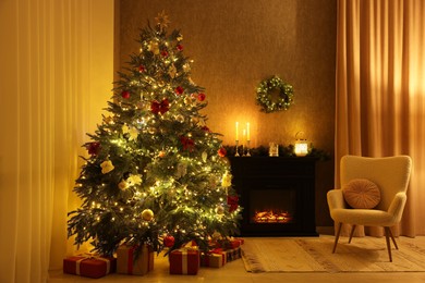 Photo of Cozy room with Christmas tree, fireplace and armchair. Interior design for holiday