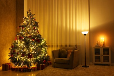 Photo of Cozy room with beautiful Christmas tree, armchair and lamp. Interior design for holiday