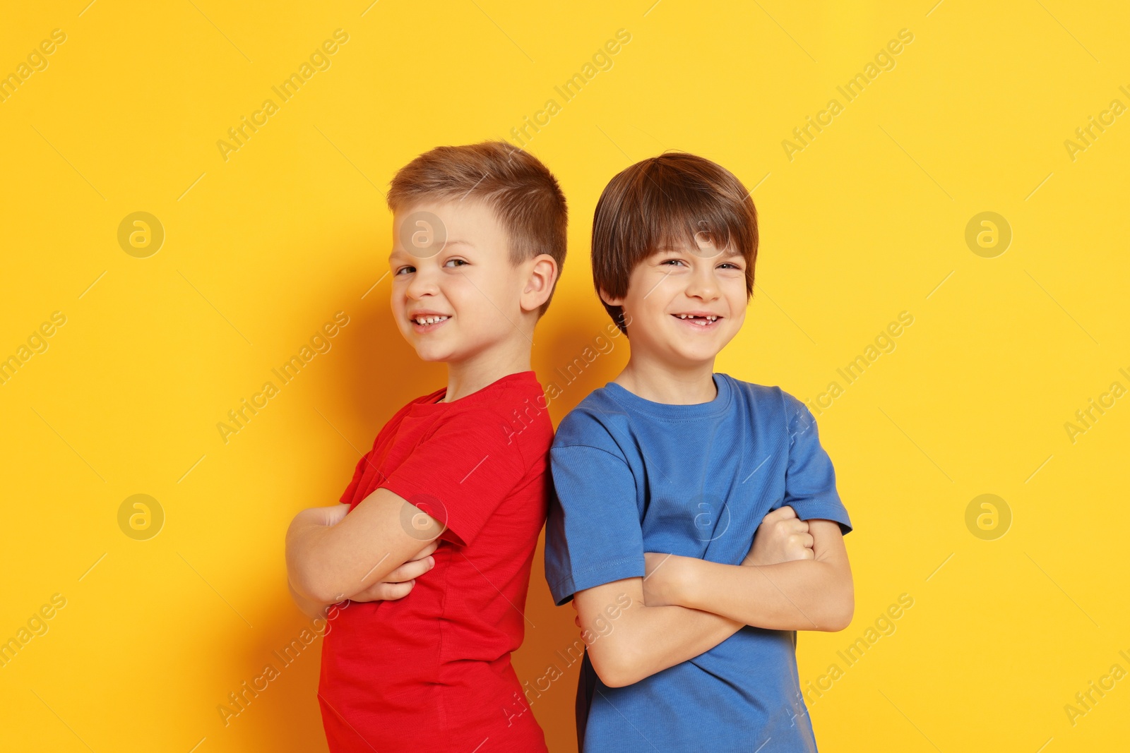 Photo of Portrait of cute brothers on orange background