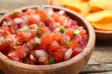 Delicious salsa in bowl on table, closeup