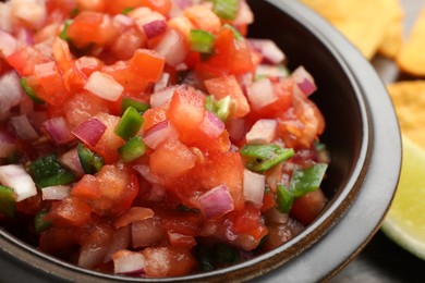 Photo of Delicious salsa in bowl on table, closeup