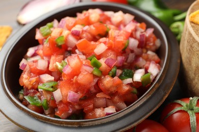 Photo of Delicious salsa in bowl on table, closeup