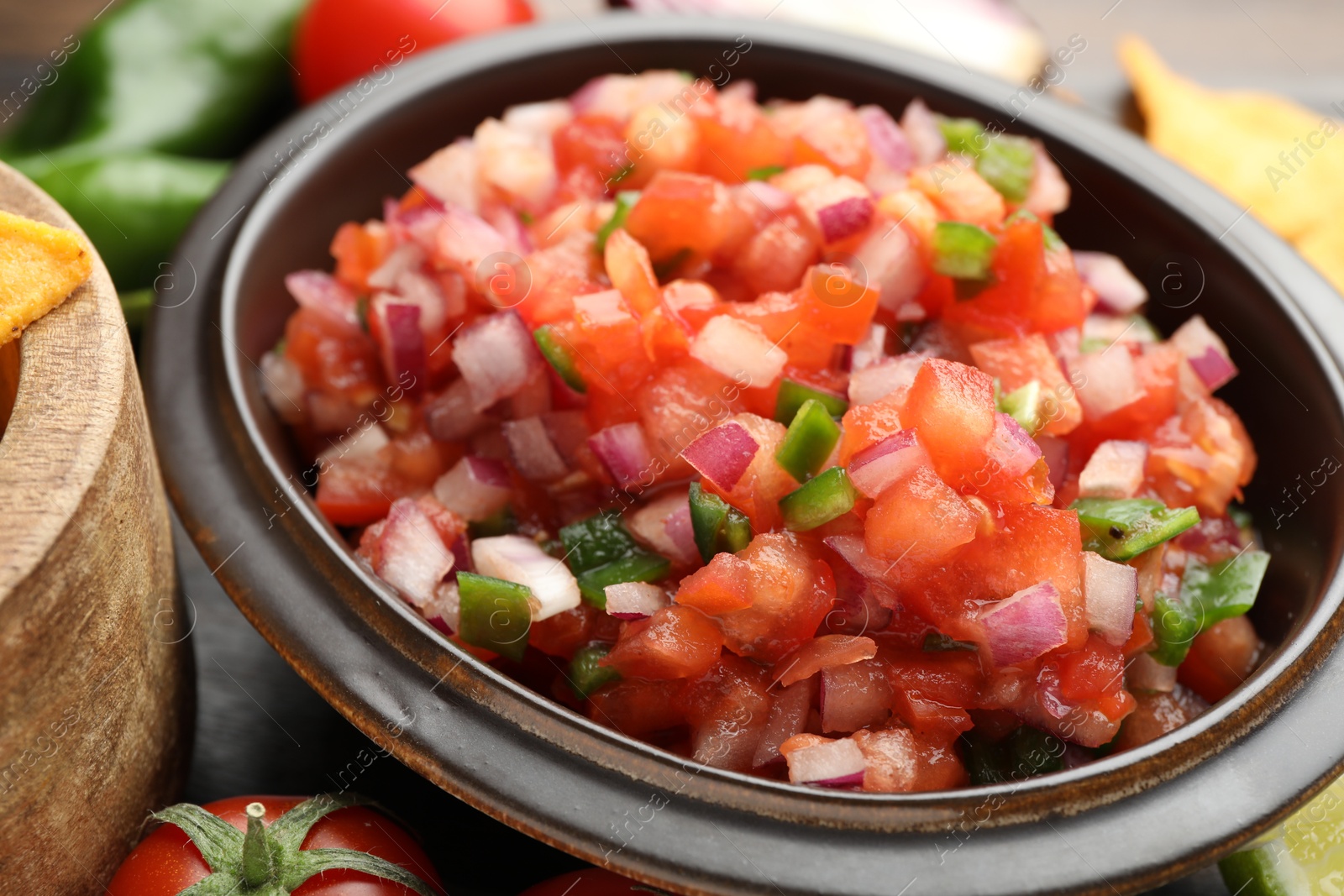 Photo of Delicious salsa in bowl on table, closeup