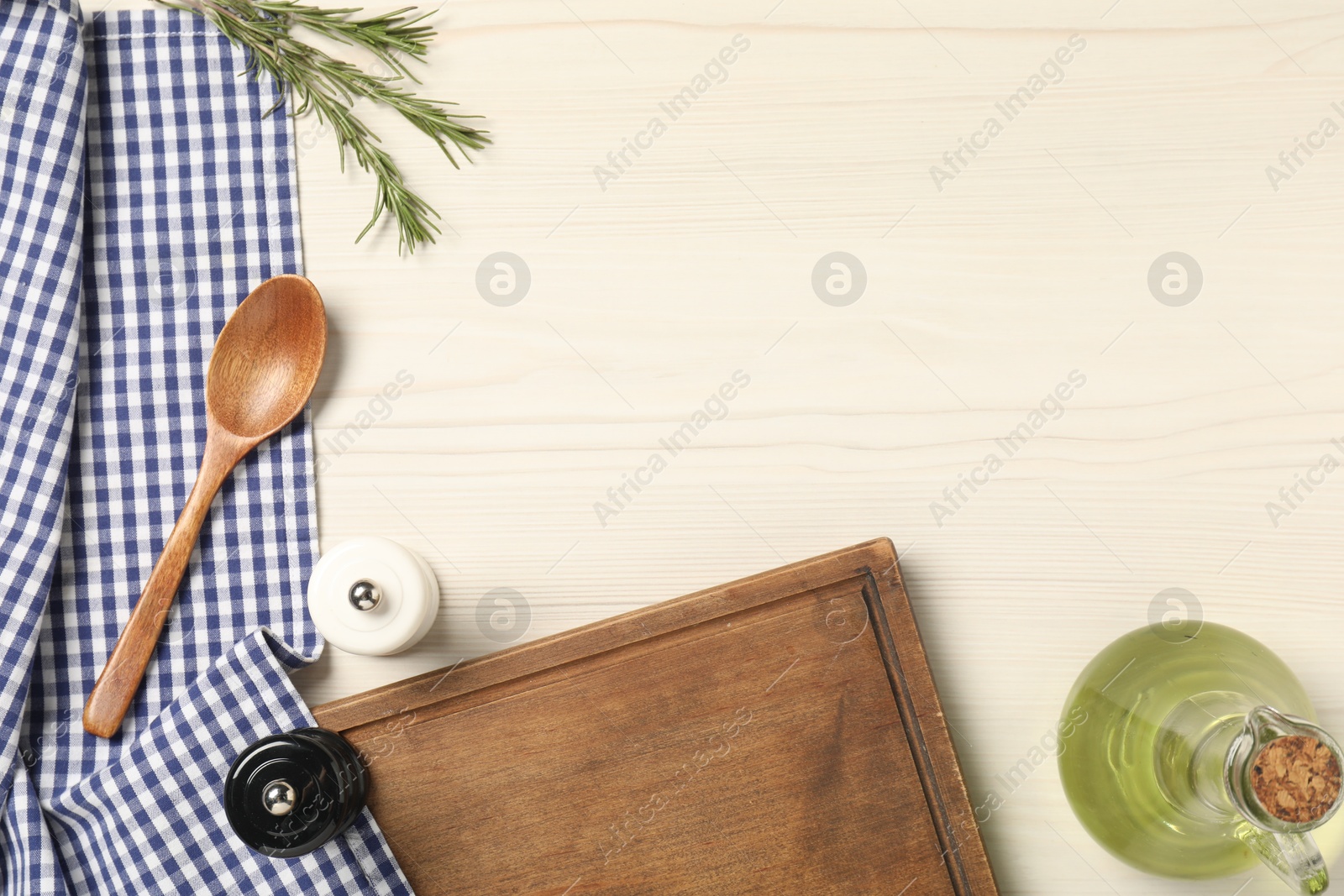 Photo of Checkered tablecloth, cutting board, spices and spoon on white wooden table, flat lay. Space for text