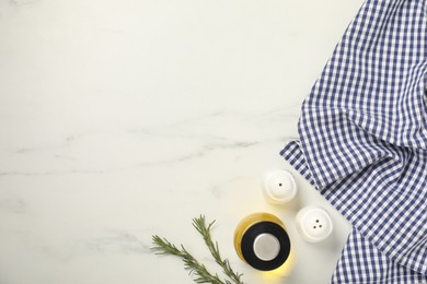 Photo of Checkered tablecloth, rosemary, spices and oil on white marble table, flat lay. Space for text