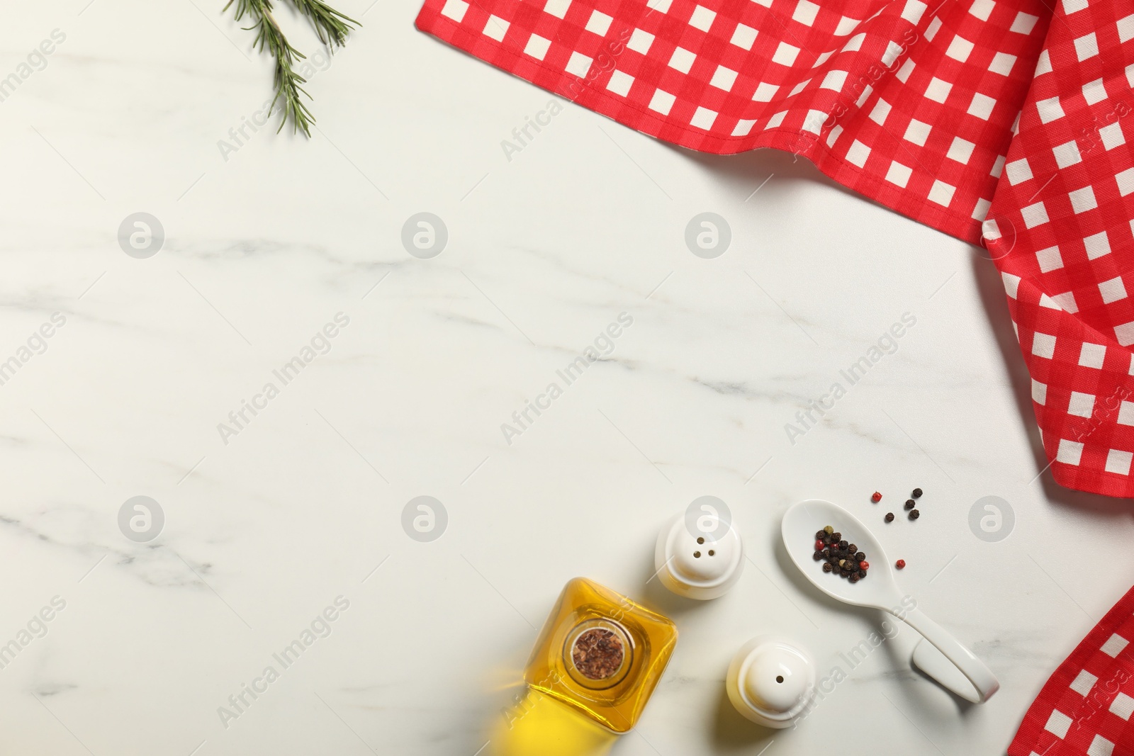 Photo of Checkered tablecloth, oil and spices on white marble table, flat lay. Space for text