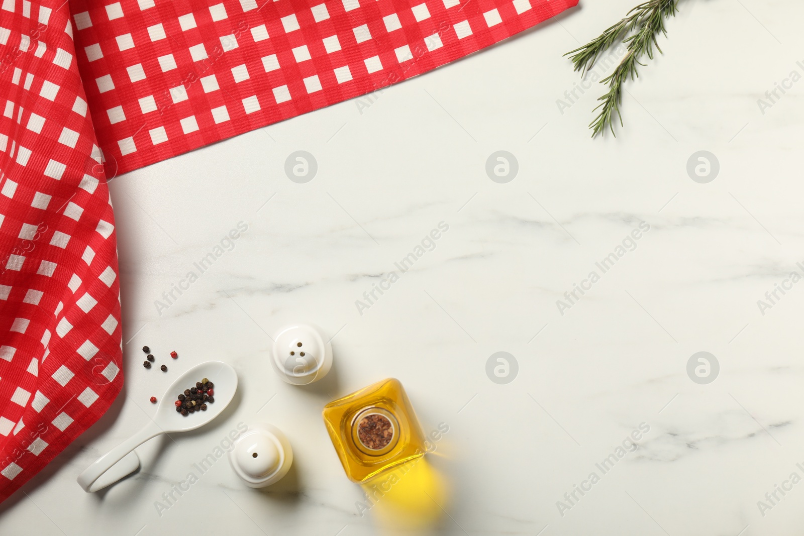 Photo of Checkered tablecloth, oil and spices on white marble table, flat lay. Space for text