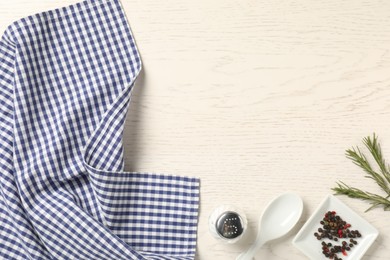 Photo of Checkered tablecloth and spices on white wooden table, flat lay. Space for text