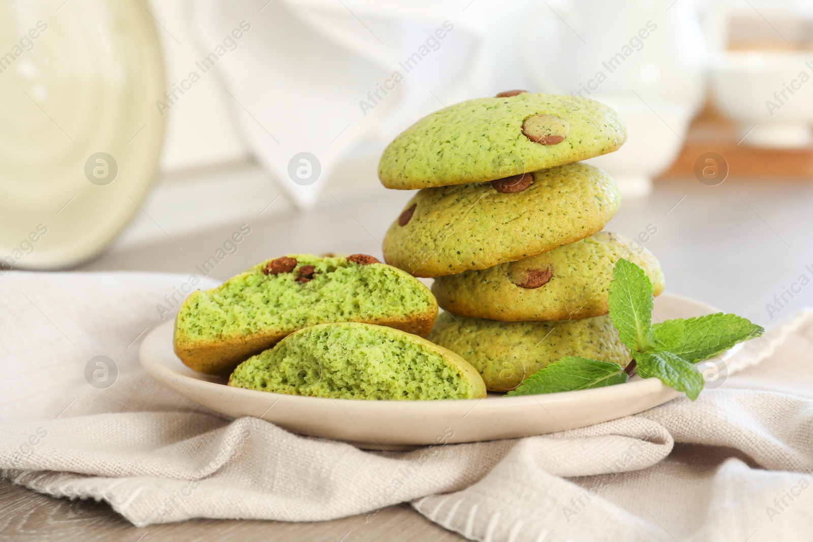 Photo of Delicious mint chocolate chip cookies on wooden table, closeup